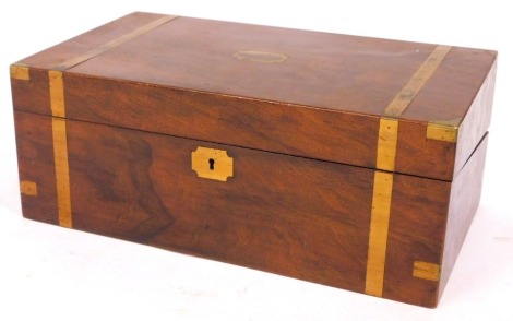 A 19thC mahogany campaign writing box, with brass bound decoration and shield, with a fitted and liner interior, 17cm high, 44cm wide, 26cm deep. (AF)