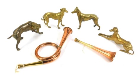 Four brass model dogs, together with a copper and brass hunting horn, of twisted design, 52cm long, and a further hunting horn, 21.5cm long. (6)