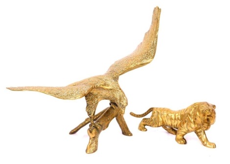 Two brass animals, comprising a brass tiger, 39cm long, and an eagle on perch, 54cm high, 58cm wide. (2)