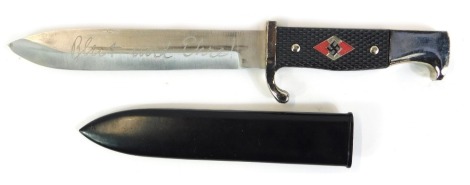 A replica Third Reich dagger, with stainless steel blade, and a black plastic moulded handle, the blade inscribed Blut und Ehre, 29cm high.