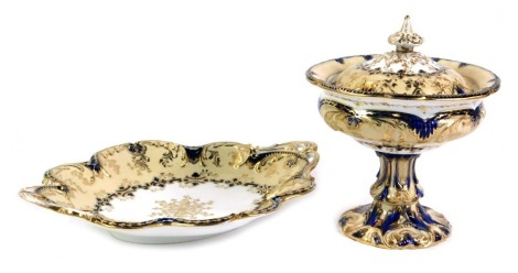 A 19thC Ridgways porcelain part dessert service, on a cream ground with gilded and royal blue border, comprising urn and cover, 20cm high, and an oval fluted serving tray, 30cm wide. (2)