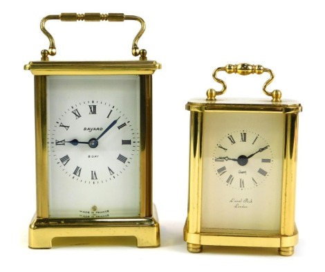 Two brass carriage timepieces, comprising Bayard France brass cased clock with white enamel dial with Roman numerals and eight day movement, 11cm high, with swing handle, and another marked Lionel Peck of London, 8cm high. (2)