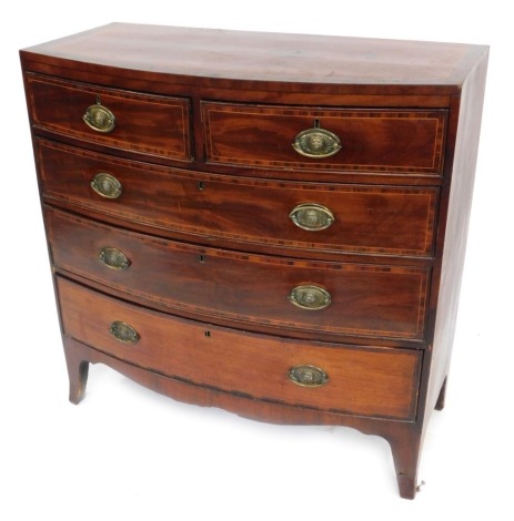 A late George III mahogany bow fronted chest, of two short and three long drawers, with boxwood inlay and brass lion mask handles, on bracket feet, 105cm high, 104cm wide, 45cm deep.