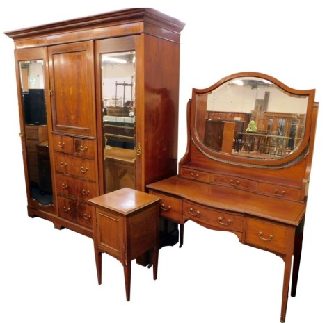 An Edwardian inlaid flame mahogany bedroom suite, comprising wardrobe compactum, with moulded cornice, two mirrored doors revealing hanging compartments, centre having shelved cupboard, and two over three graduated drawers with brass loop handles and bra