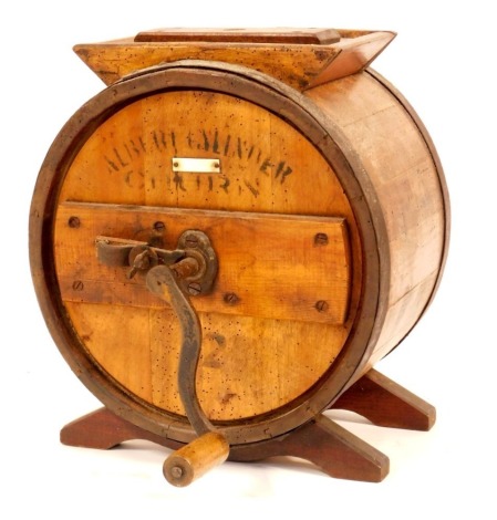 An Albert Slinger tabletop butter churn, of pine and beech, with iron straps and handle, bears label for Armley of Boston, 45cm high, 36cm wide.