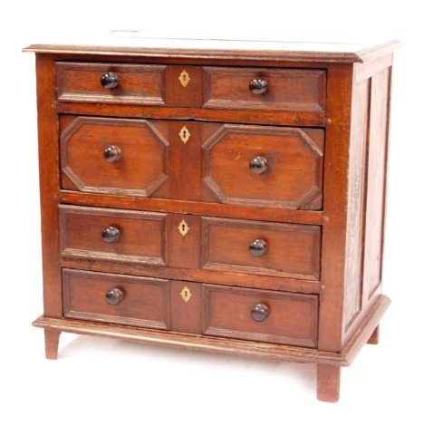 A late 17thC oak chest, of four graduated drawers, with later knop handles and brass key plates, on stile feet, 86cm high, 88cm wide, 54cm deep.