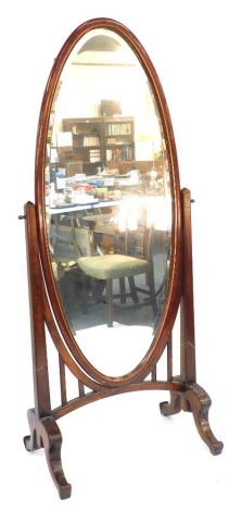 A Continental red lacquered cheval mirror, of oval design, on a stained hardwood frame, 190cm high, 80cm wide, 54cm deep.