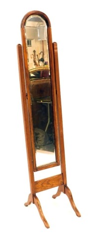 A 20thC oak framed cheval mirror, of slender design with an arched top, 180cm high, 36cm wide, 52cm deep.