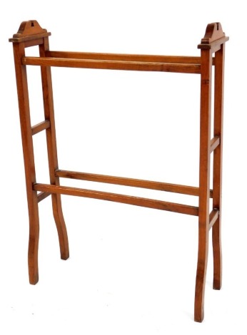 A walnut towel rail, with arched stiles, 90cm high, 60cm wide, 22cm deep.