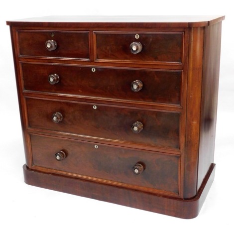 A Victorian mahogany chest, of two short and three long drawers, with turned handles, each inlaid with mother of pearl, on plinth base with rounded corners, 103cm high, 113cm wide, 53cm deep.