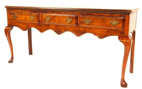 A late 19thC mahogany dresser base, with rectangular top above arrangement of three drawers with brass swing handles, on pad feet, 73cm high, 152cm wide, 42cm deep.