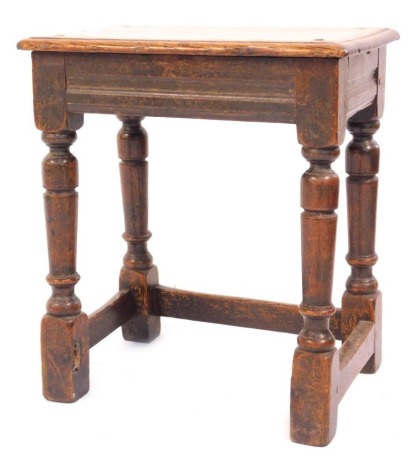 An early 19thC oak joint stool, the rectangular top on four turned supports, 45cm high, 40cm wide, 25cm deep, one stretcher missing.