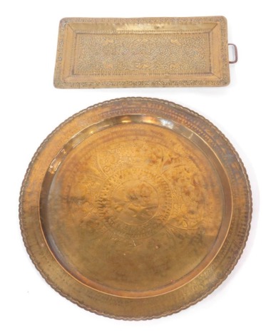 Indian brass wares, comprising a circular brass charger, with floral decoration and a petallated border, 58cm diameter, and a rectangular tray with one handle and bird decoration, 52cm x 24cm. (2)