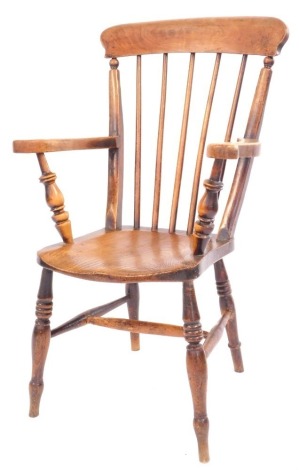 A late 19thC elm and beech stick back arm chair, with an arched rail and turned legs, 99cm high, 56cm wide, 46cm deep.