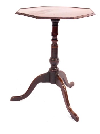 A George III mahogany octagonal tripod table, on a turned tripod columns with cabriole legs, 66cm high, the top 50cm x 50cm.