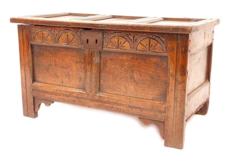 A 17thC oak coffer, with a three panelled lid, arcaded frieze, twin panelled front, with candle box to the interior, terminating on stiles, 55cm high, 100cm wide, 50cm deep.