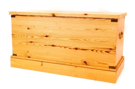 A pine blanket box, of plain design with brass swing handles, 57cm high, 108cm wide, 46cm deep.