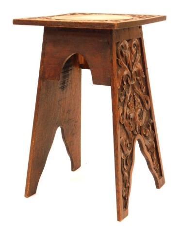 An oak stand, the square top with carved foliate scrolls, on carved support, 51cm high, the top 30cm x 30cm.