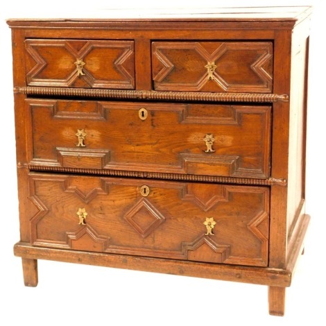 A 17thC oak chest, of two short and two long drawers, with carved cross moulding and brass fish tail handles, on stiles, 88cm high, 89cm wide, 53cm deep. (AF)