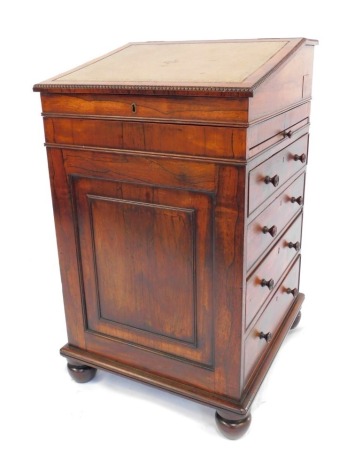 A Victorian rosewood Davenport, with slide top, slide side, and an arrangement of four graduated drawers with knob handles, 52cm wide.