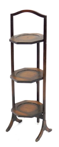 A 1930s oak three tier folding tea stand, 94cm high, 27cm wide.