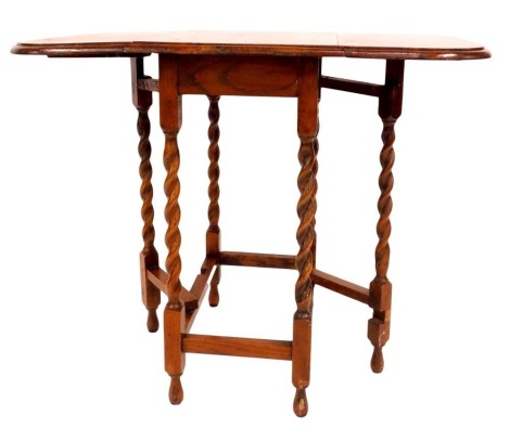 A 1920s oak and beech gate leg table, with spiral column supports, 73cm high, 60cm wide, 47cm deep.