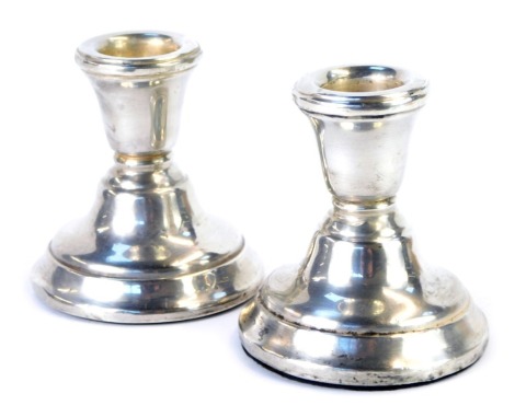 A pair of Elizabeth II loaded silver candlesticks, of squat form, Birmingham 1968, 6.51oz all in, 7.5cm high.