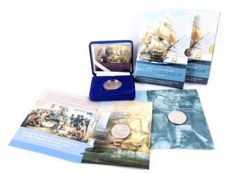 A United Kingdom 2005 silver proof commemorative crown, for The Bicentennial of The Battle of Trafalgar 21st October 1805, boxed, and two United Kingdom 2005 brilliant uncirculated two crown commemorative sets. (3)