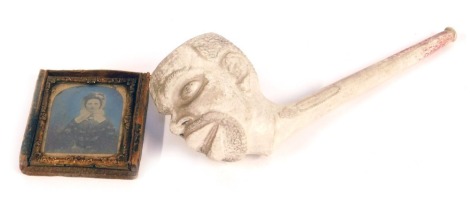 A 19thC clay pipe, modelled the head of a black man, bears registration lozenge, 19cm wide, together with a Victorian daguerreotype photograph of a lady. (2)