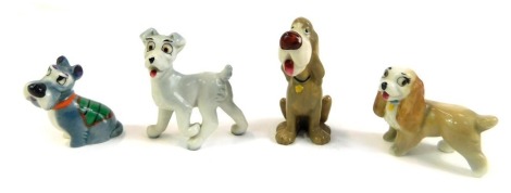 Four Wade Disney dog figures.