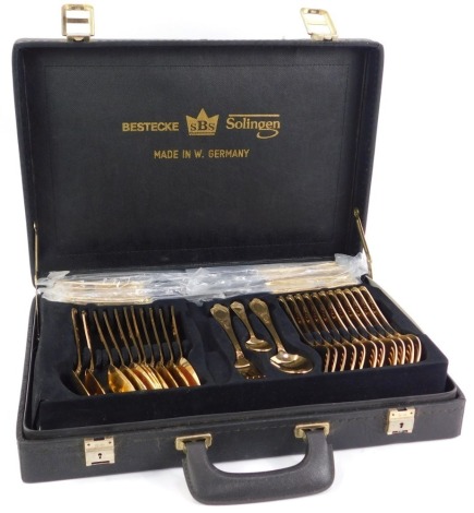 An SBS Solingen gilt plated canteen of cutlery, twelve place settings, cased.