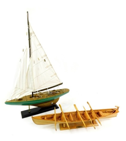 A wooden scale model of a Pilot Gig, with stand, 49cm wide, together with a model of a yacht, on stand, 41cm wide. (2)