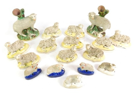 A group of 19thC Staffordshire pottery figures of ewes and rams, including a pair of spill vases, and two ink wells, pairs and singles. (a quantity)