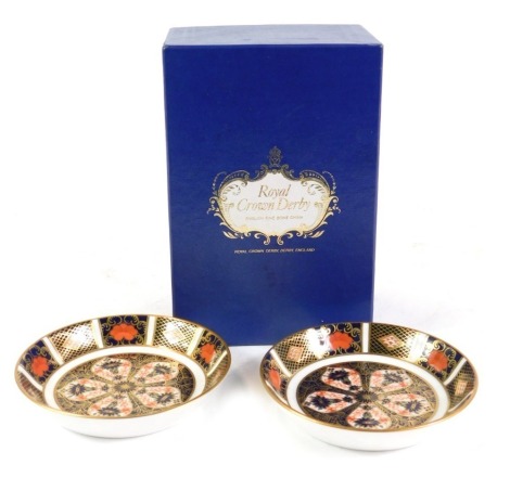 A pair of Royal Crown Derby Imari porcelain circular spoon dishes, pattern 1128, together with an Imari candle snuffer, boxed. (3)