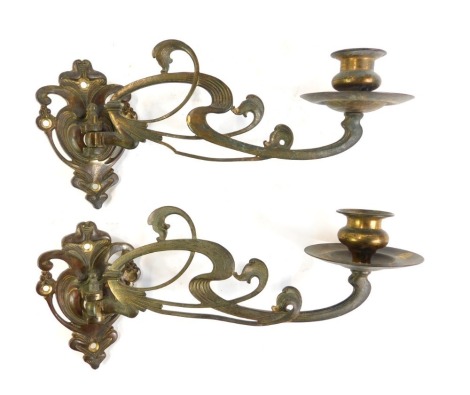 A pair of Art Nouveau copper piano sconces, with scrolling leaf decoration, 23cm long.