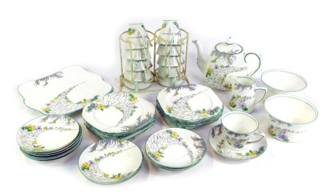 An early 20thC Heathcote china The Pathways pattern tea service, printed marks, comprising pair of bread plates, teapot, cream jug, pair of sugar bowls, eleven teacups, twelve saucers and tea plates.