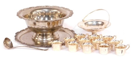 A silver plated punch bowl, together with twelve cups, ladle, a salver or stand, and a plated basket.