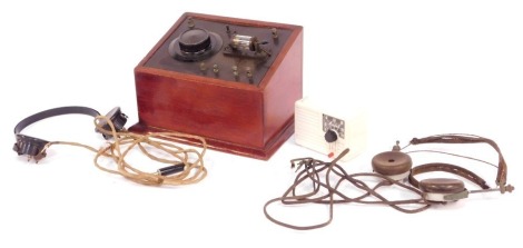 A vintage crystal radio set, with headphones, mahogany cased, together with an Ivalek Deluxe crystal set, boxed, and a further pair of headphones.