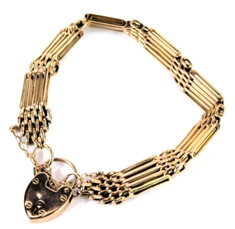 A gold five bar gate bracelet, rose metal, on a heart shaped padlock clasp, with safety chain as fitted, stamped 9ct, 20.3g.