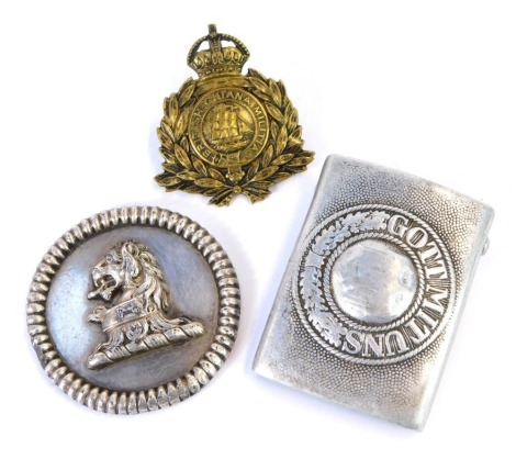 A 19thC armorial boss, silver plated, with a lion's head crest, lead filled, and a Third Reich alloy belt buckle 'Gott Mituns', and a British Guiana Militia badge. (3)