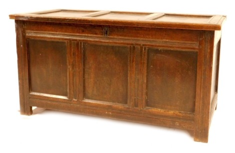 A 17thC oak coffer, with triple panelled lid and front, on moulded stile supports, 112cm wide, 51cm deep.