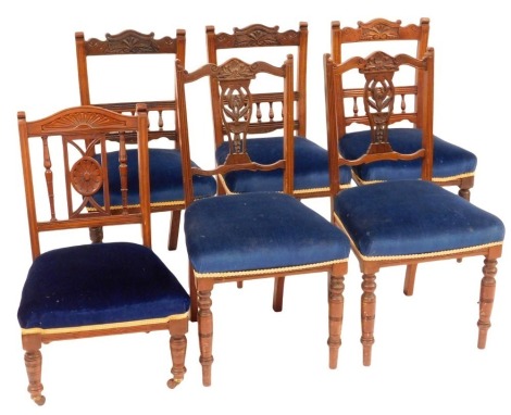 A set of six Edwardian dining chairs, with carved cresting rails and pierced and carved splats, over upholstered seats on slender turned supports, later reupholstered in blue draylon.