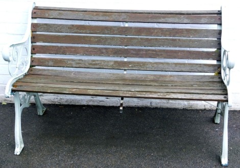 A bench, with cast metal ends and slatted seat and back, 129cm wide.