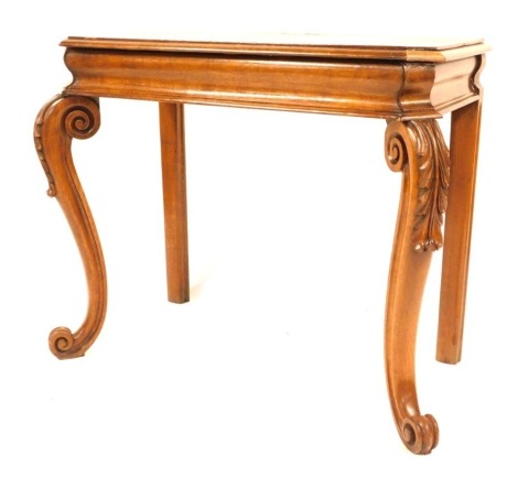 A rectangular oak side table, the top with canted corners and moulded border above an ogee frieze, raised on acanthus capped scrolling legs and feet, 83cm high, 104cm wide, 52cm deep.