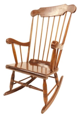 A stained beech spindle back rocking chair, on turned supports and stretchers.