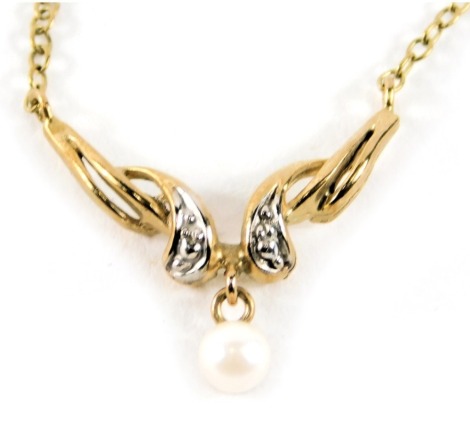 A 9ct gold pendant and chain, the pendant formed as two wings with cultured pearl drop and set with tiny diamonds, on a fine link neck chain, 42cm long, 1.7g all in.