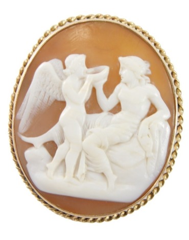 A 19thC shell cameo brooch/pendant, with raised relief figure reclined on sofa and winged figure drinking from bowl, 3cm x 4cm, in a yellow metal rope twist border with single pin back and pendant mount, the cameo signed to reverse Dolani, yellow metal un