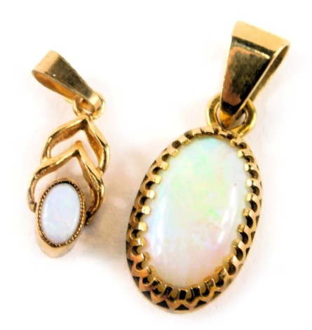 Two opal pendants, comprising a 9ct gold and opal crossover pendant, 1.5cm high, and an opal and yellow metal mounted oval pendant, 2.5cm high, unmarked, 2.2g all in. (2)