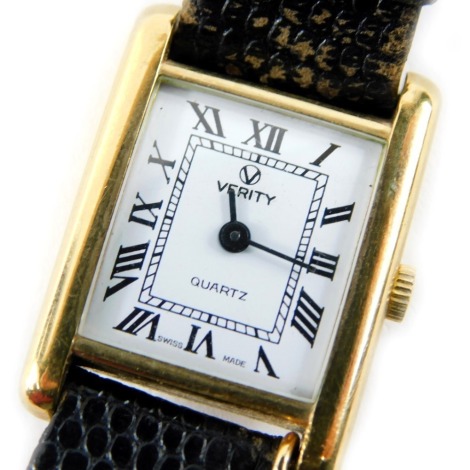 A 9ct gold cased Verity wristwatch, the rectangular watch head on white enamel Roman numeric dial, on a black leather strap, with St Christopher charm, the dial 1.5cm diameter, 21.5g all in.