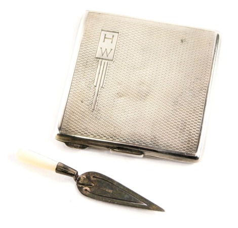 Two items of silver, comprising a George VI silver compact, of engine turned decoration bearing the initials HW, maker S&B Birmingham 1947, and a white metal and mother of pearl handled presentation miniature trowel, 2.62oz gross. (2)